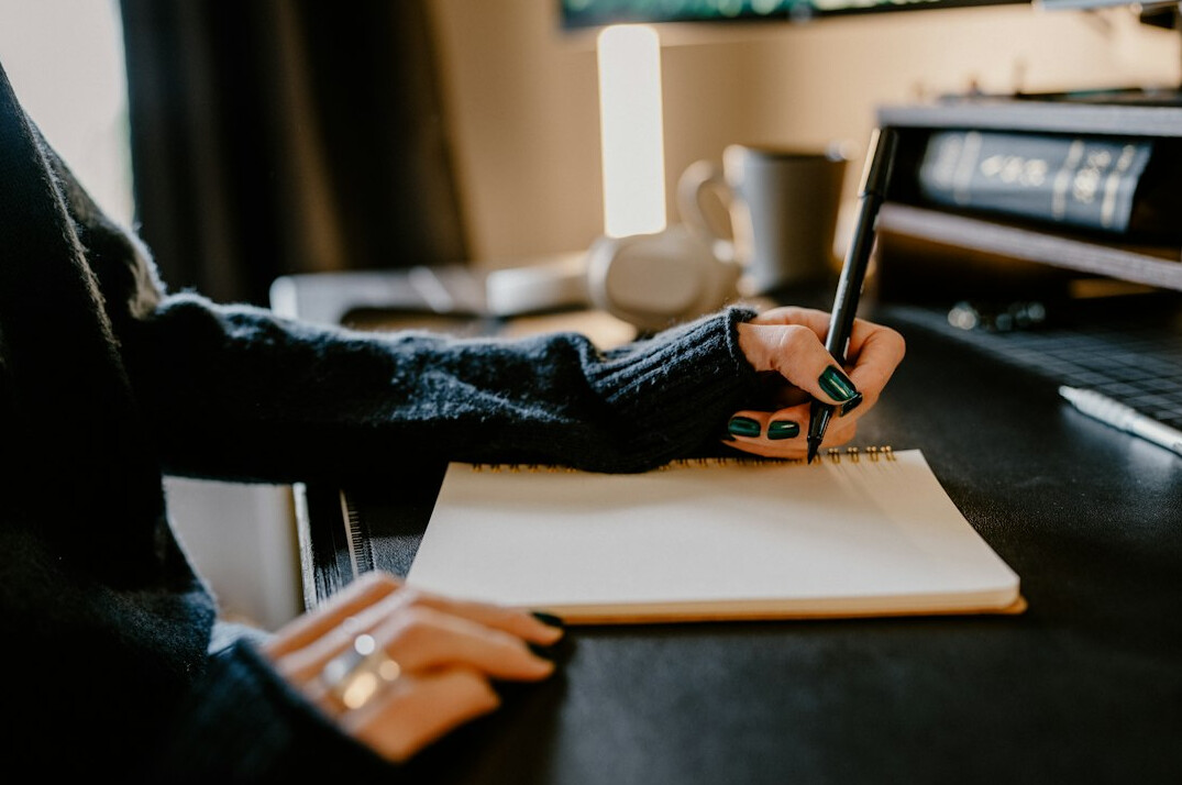 writer at desk with notebook