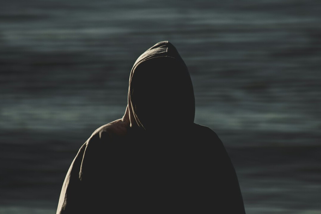 mysterious figure in coat